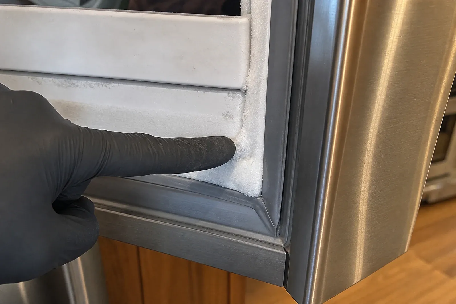 Technician checking the frost line and evaporator on a built-in Sub-Zero freezer in Santa Rosa